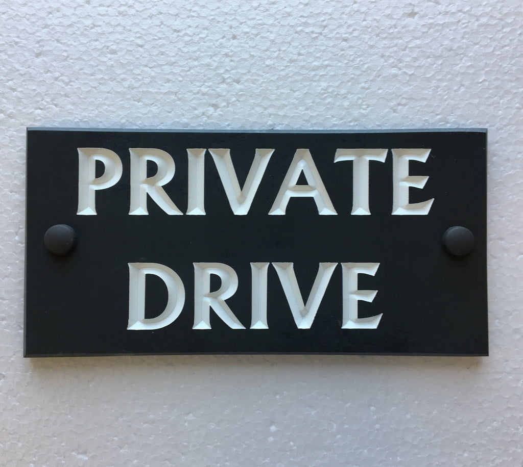 House sign measuring 200mm x 100mm using black Corian with the address deep engraved and infilled with white monument paint