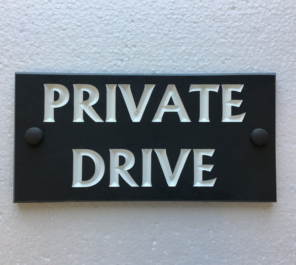 House sign measuring 200mm x 100mm using black Corian with the address deep engraved and infilled with white monument paint