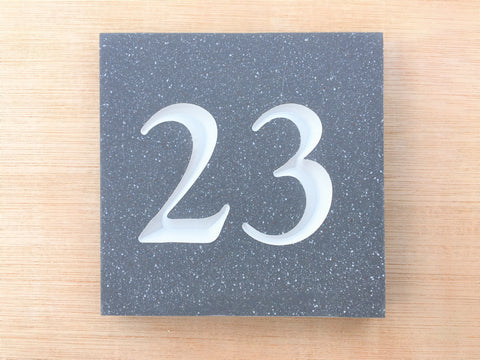 House sign measuring 100mm x 100mm using grey Corian with the number 23 deep engraved and infilled with white monument paint