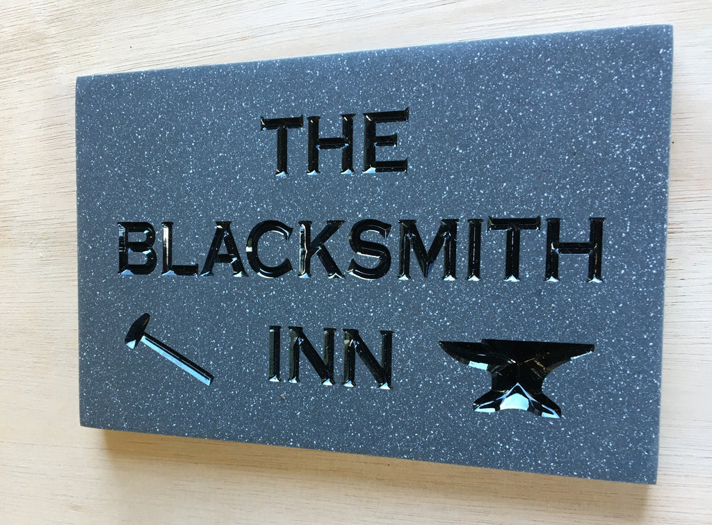 House sign measuring 200mm x 150mm using grey Corian with the address deep engraved and infilled with black monument paint