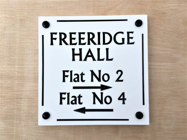 House sign measuring 200mm x 200mm using white Corian with a line border and the address name and numbers deep engraved and infilled with white monument paint