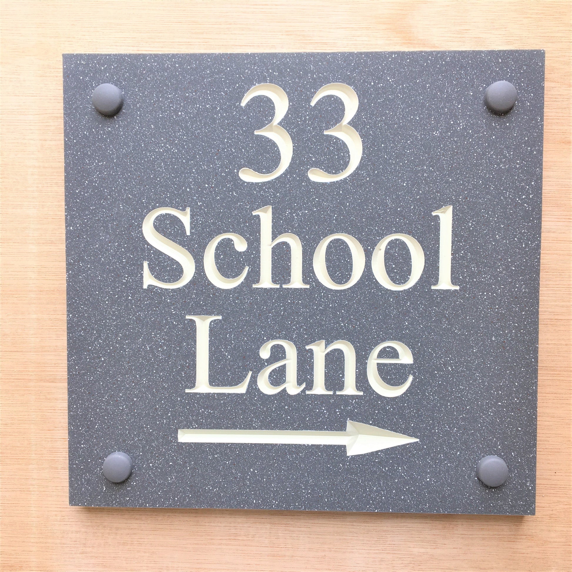 House sign measuring 200mm x 200mm using grey Corian with the address and numbers deep engraved and infilled with white monument paint