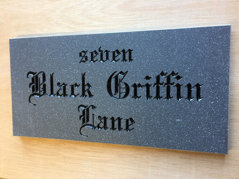 House sign measuring 300mm x 150mm using grey Corian with the address and numbers deep engraved and infilled with black monument paint