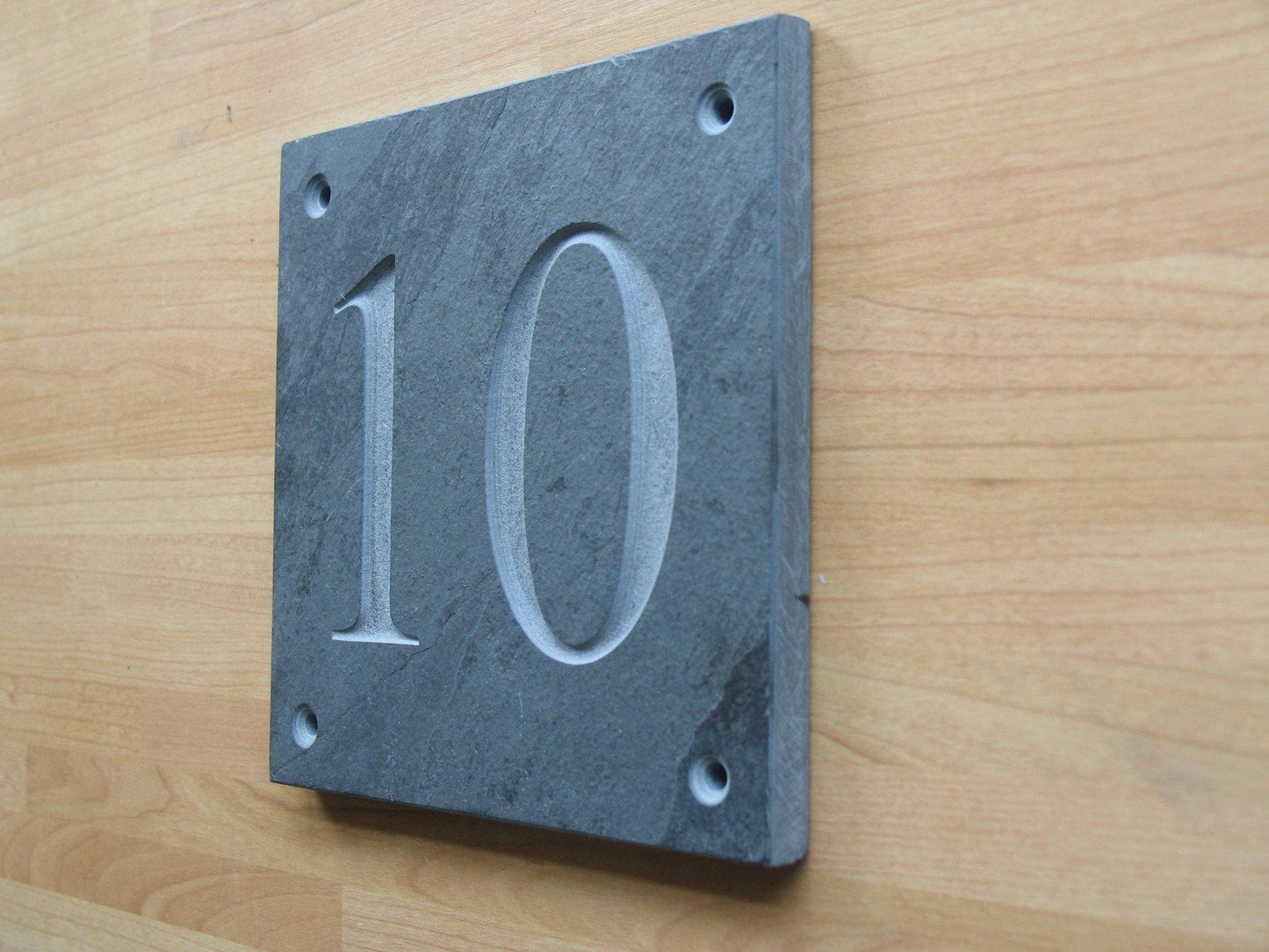 Slate house sign with house number 10 on a 100mm x 100mm  using Times New Roman font -on grey slate with no paint