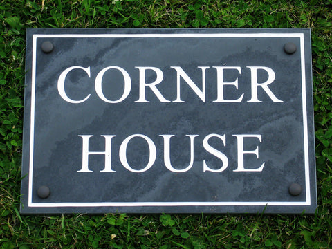 Slate house sign measuring 300mm x 200mm with the address and plain border deep engraved and infilled with white monument paint