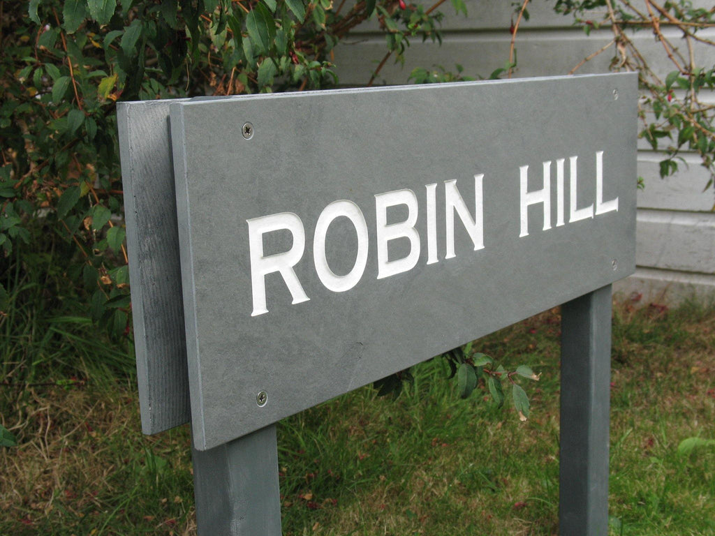 A sign reading "Robin Hill" in a picturesque location.