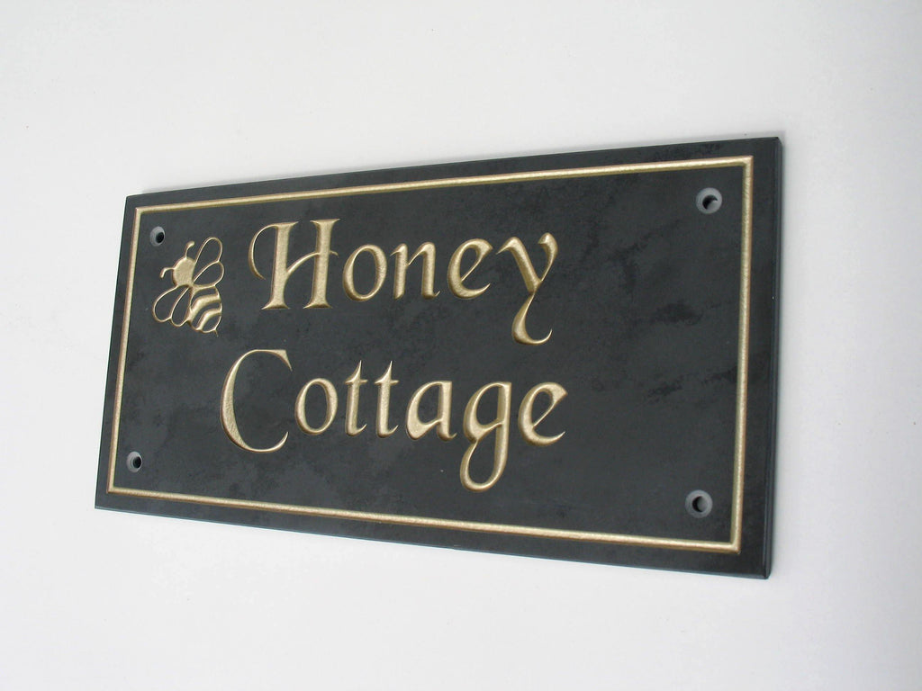 Slate house sign measuring 400mm x 200mm with the name engraved on charcoal slate with gold paint and a plain border