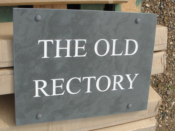 A slate house sign, measuring 400mm x 300mm, deep-engraved The Old Rectory in Times New Roman font, on grey slate, enhanced with white paint. 